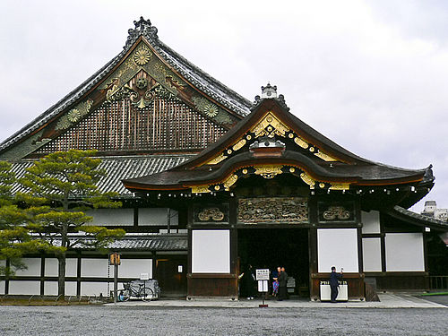 Nijo castle portray a front fascade. The front shows Intricate wood carvings and decorative panels.