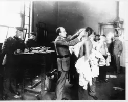 Health inspectors examine detainees on Angel Island, ca. 1917. (90-G-124-11) National Archives and Records Administration