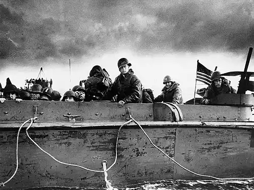 Troops and crewmen aboard a U.S. Coast Guard manned LCVP as it approaches a Normandy beach on "D-Day", 6 June 1944.