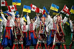 Image of Ukrainian dancers with Ukrainian and Canadian flags
