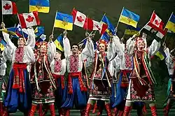 Image of Ukrainian dancers with Ukrainian and Canadian flags